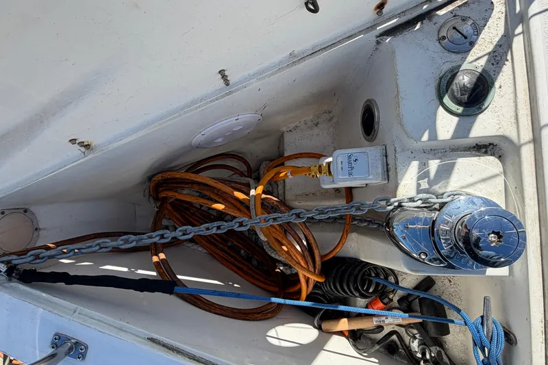 Slide: The Image of Anchor locker of a 1998 Catalina 380 sailboat with chain, ropes, and winch. - 50