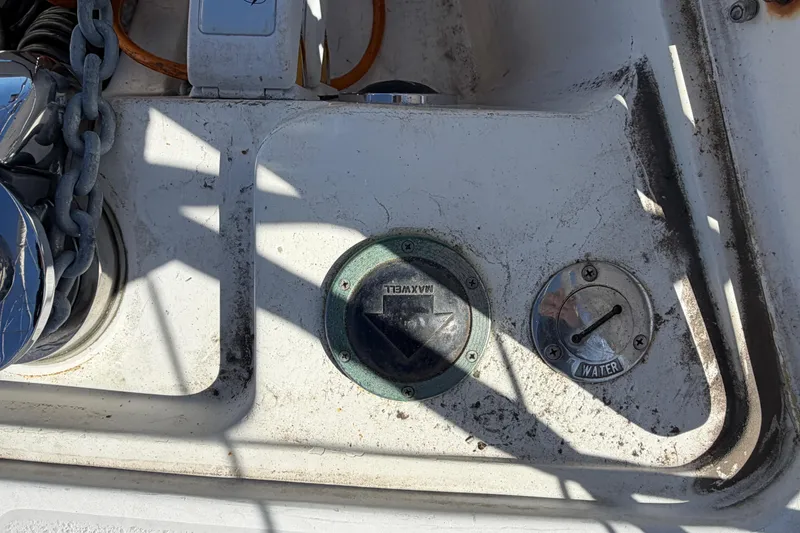 Slide: The Image of Deck fittings on a 1998 Catalina 380 sailboat, including water and chain access. - 51