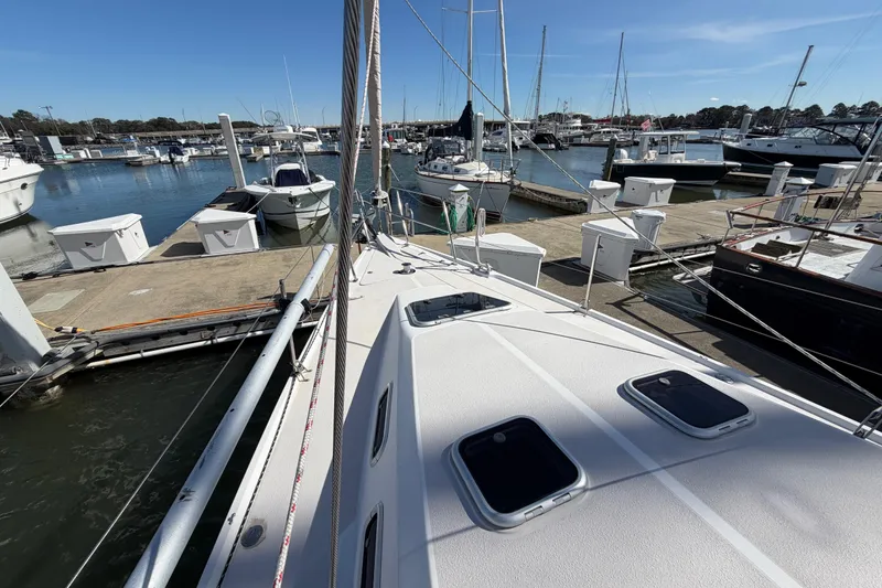 Slide: The Image of 1998 Catalina 380 sailboat docked at a marina under clear blue skies. - 52