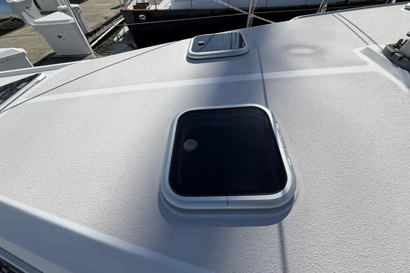 Slide: The Image of Deck view of a 1998 Catalina 380 sailboat with hatches and textured surface. - 54