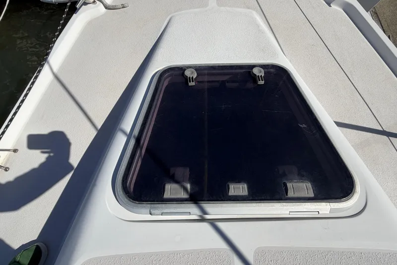 Slide: The Image of Deck hatch of a 1998 Catalina 380 sailboat, showing a closed window. - 55