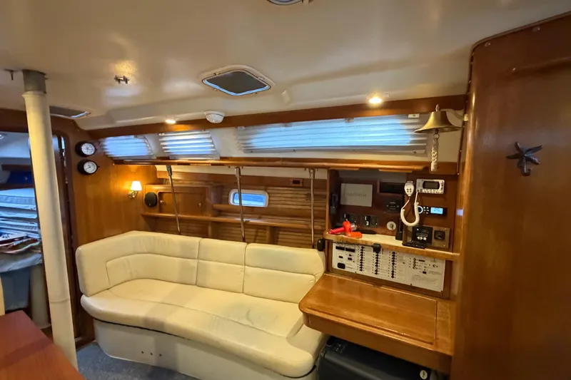Slide: The Image of Interior of 1998 Catalina 380 yacht with cozy seating and navigation equipment. - 6