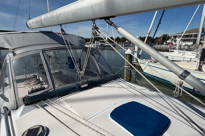 Slide: The Image of 1998 Catalina 380 sailboat docked, featuring a spacious deck and rigging. - 61