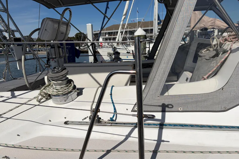 Slide: The Image of Sailboat deck of a 1998 Catalina 380, featuring winch and ropes in a marina. - 64