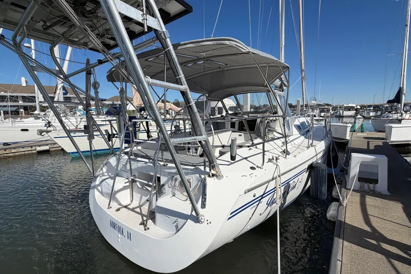 Slide: The Image of 1998 Catalina 380 sailboat docked at marina under clear blue sky. - 66