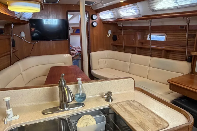 Slide: The Image of Interior of a 1998 Catalina 380 sailboat with cozy seating and modern amenities. - 9