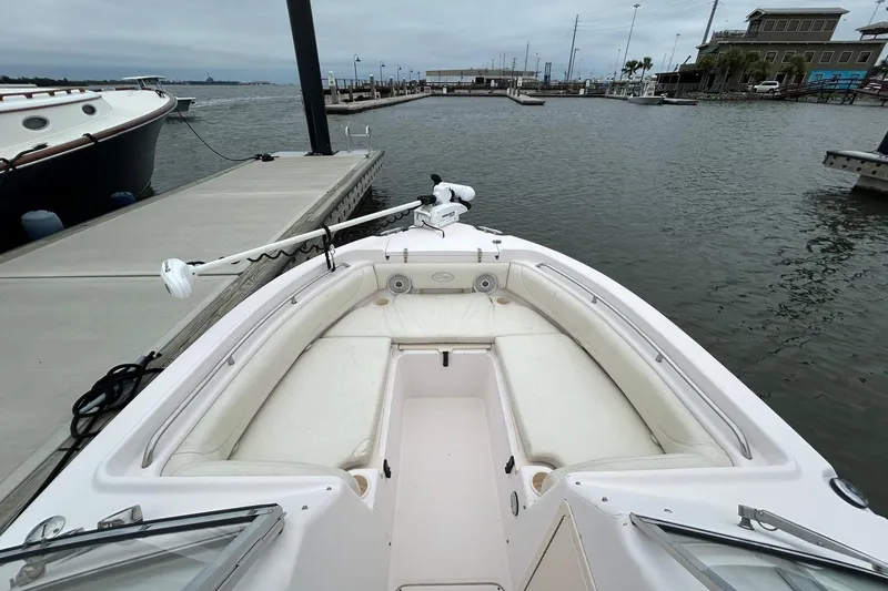 Slide: The Image of 2011 Grady-White Freedom 225 boat docked at marina, featuring spacious seating and calm waters. - 15