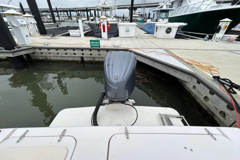 Slide: The Image of 2011 Grady-White Freedom 225 boat docked at marina with outboard motor. - 20