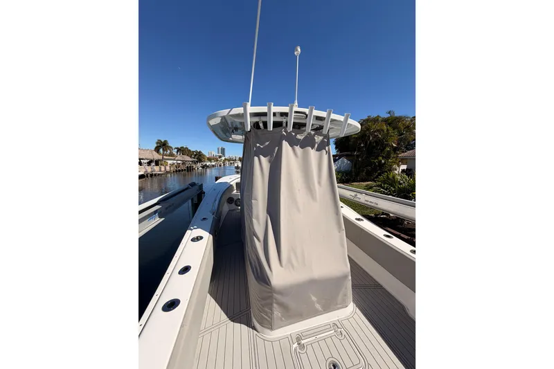 Slide: The Image of 2023 Cape Horn 32 XS boat with covered console, docked on a sunny day. - 12