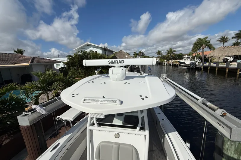 Slide: The Image of 2023 Cape Horn 32 XS boat docked by a canal under a clear blue sky. - 17