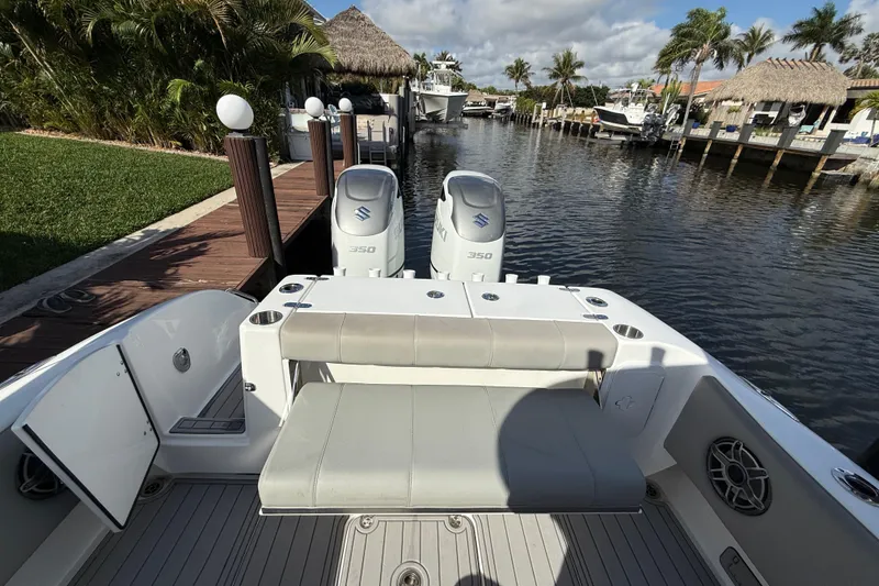 Slide: The Image of 2023 Cape Horn 32 XS boat with dual Suzuki 350 engines docked by a canal. - 18