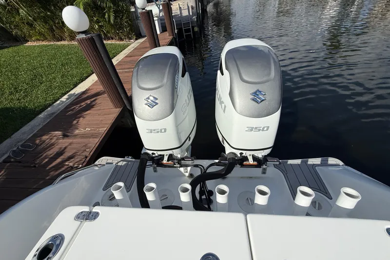 Slide: The Image of 2023 Cape Horn 32 XS boat with dual Suzuki 350 outboard engines at dock. - 19