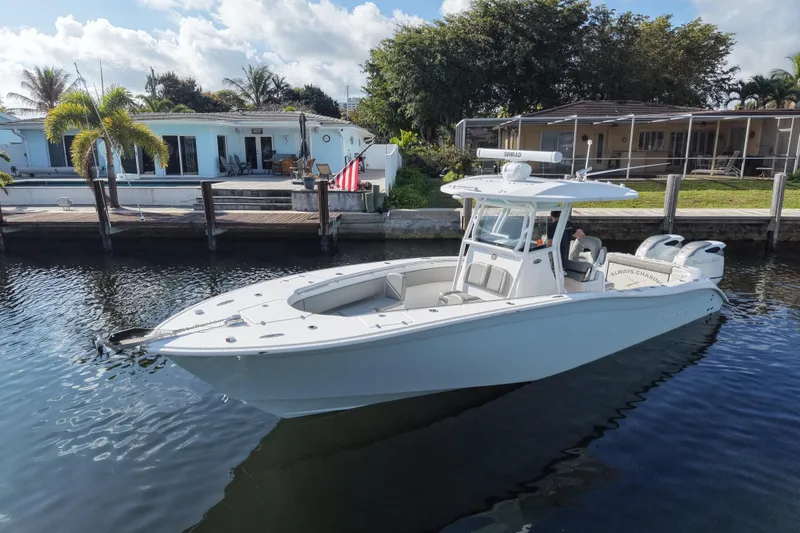 Slide: The Image of 2023 Cape Horn 32 XS boat docked by waterfront home, sunny day. - 2