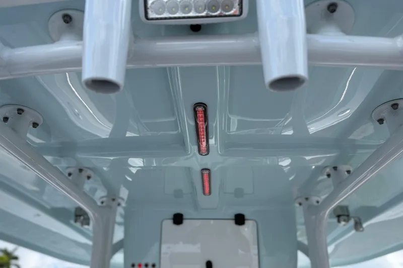 Slide: The Image of 2023 Cape Horn 32 XS boat interior ceiling with mounted lights and rod holders. - 26