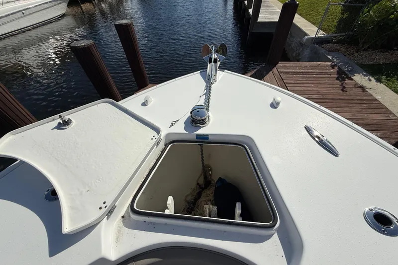 Slide: The Image of 2023 Cape Horn 32 XS boat bow with anchor storage and open hatch. - 27