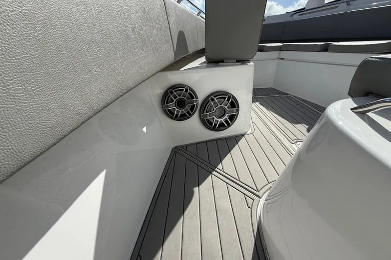 Slide: The Image of 2023 Cape Horn 32 XS boat interior with speakers and cushioned seating. - 34