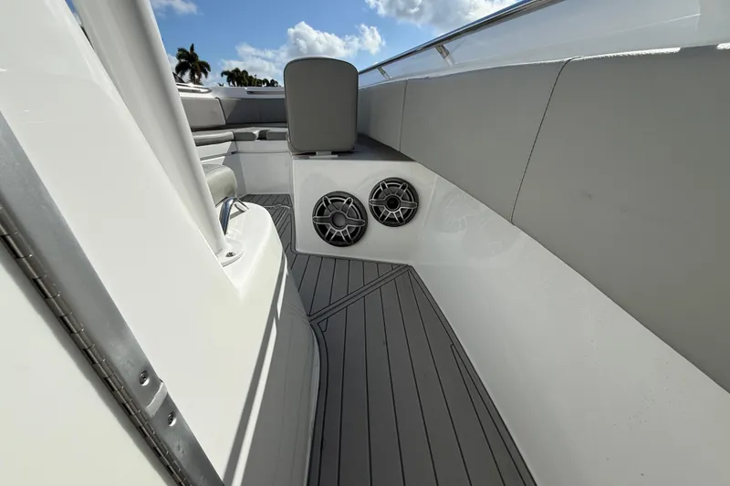 Slide: The Image of 2023 Cape Horn 32 XS boat interior with speakers and seating, under a blue sky. - 35