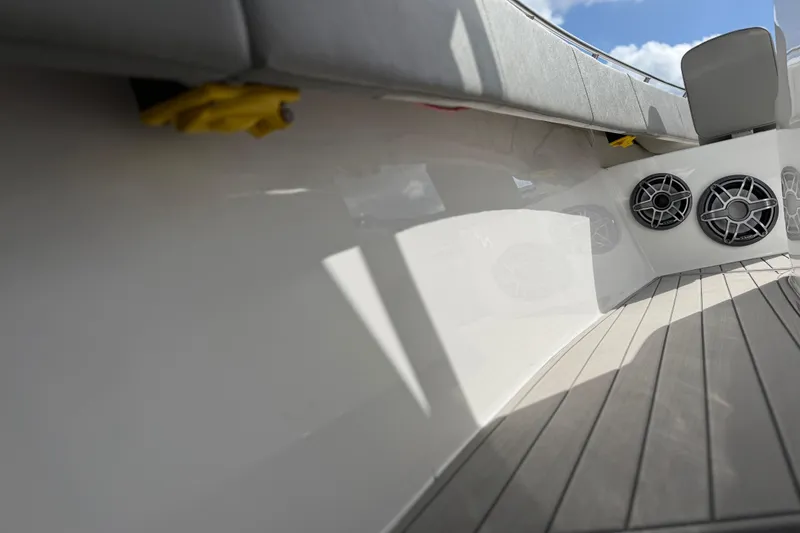 Slide: The Image of 2023 Cape Horn 32 XS boat interior with speakers and cushioned seating. - 36