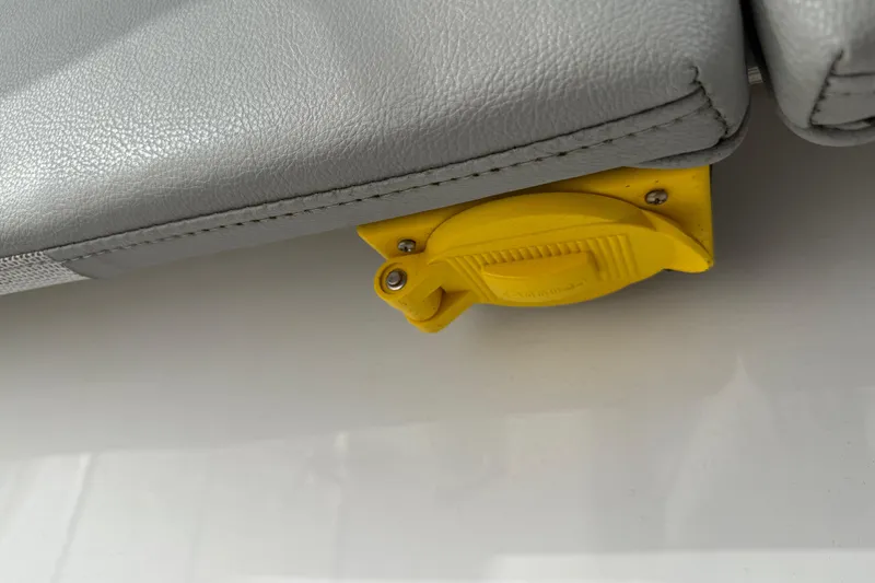 Slide: The Image of Yellow latch under gray seat on 2023 Cape Horn 32 XS boat. - 37