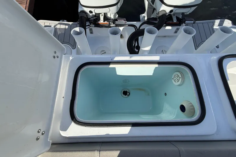 Slide: The Image of 2023 Cape Horn 32 XS boat livewell with rod holders and dual engines. - 38