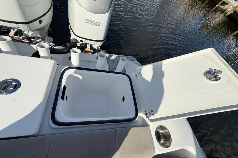 Slide: The Image of 2023 Cape Horn 32 XS boat with open storage compartment and twin outboard engines. - 39