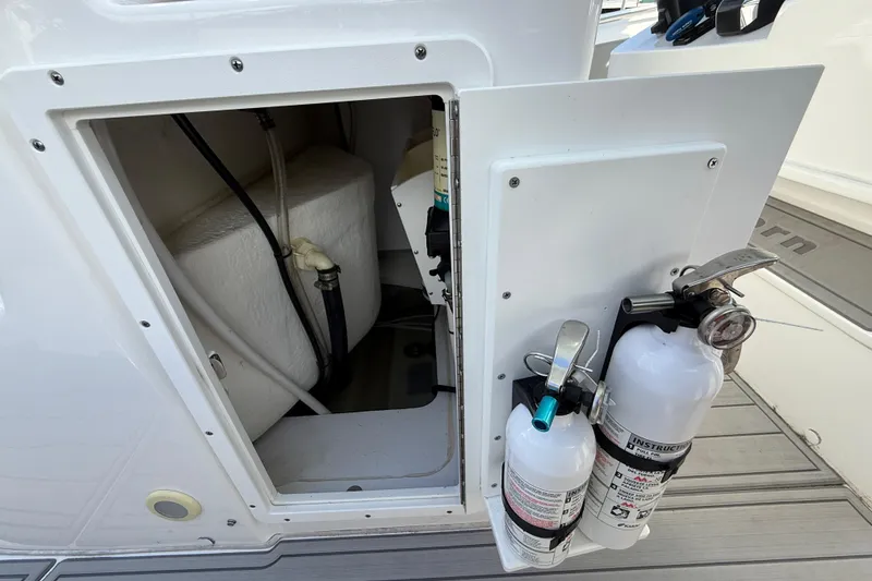 Slide: The Image of 2023 Cape Horn 32 XS boat compartment with fire extinguishers and storage space. - 42