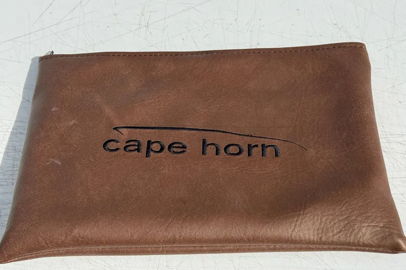 Slide: The Image of Brown leather pouch with "Cape Horn" logo, related to 2023 Cape Horn 32 XS model. - 44