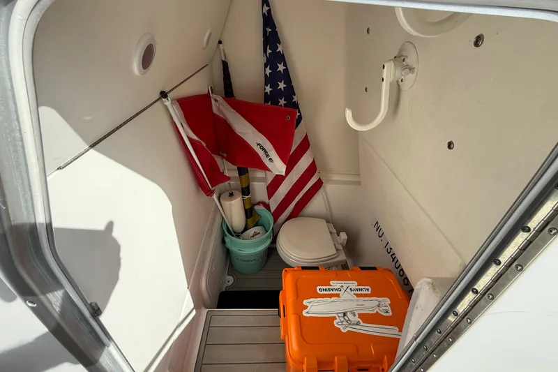 Slide: The Image of Interior of 2023 Cape Horn 32 XS boat with flags and storage items. - 45