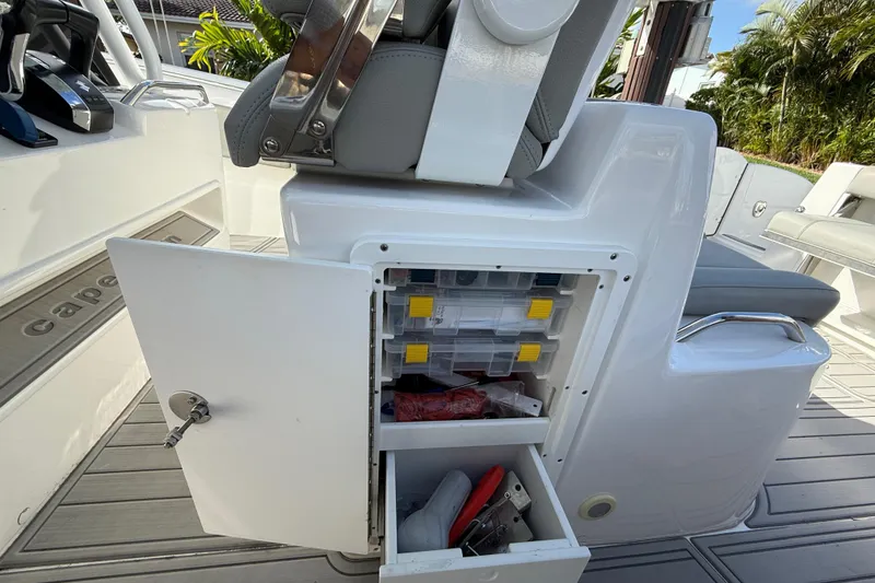 Slide: The Image of 2023 Cape Horn 32 XS boat interior with open storage compartment and seating. - 50