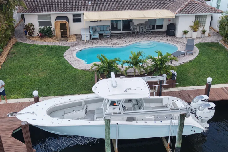 Slide: The Image of 2023 Cape Horn 32 XS boat docked by a poolside home. - 52