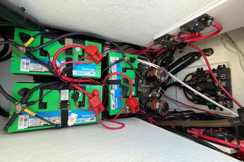 Slide: The Image of 2023 Cape Horn 32 XS boat battery compartment with wiring and connections. - 57