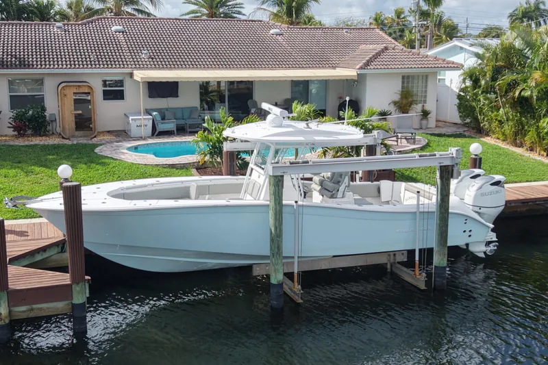 Slide: The Image of 2023 Cape Horn 32 XS boat docked by a waterfront home with a pool. - 6