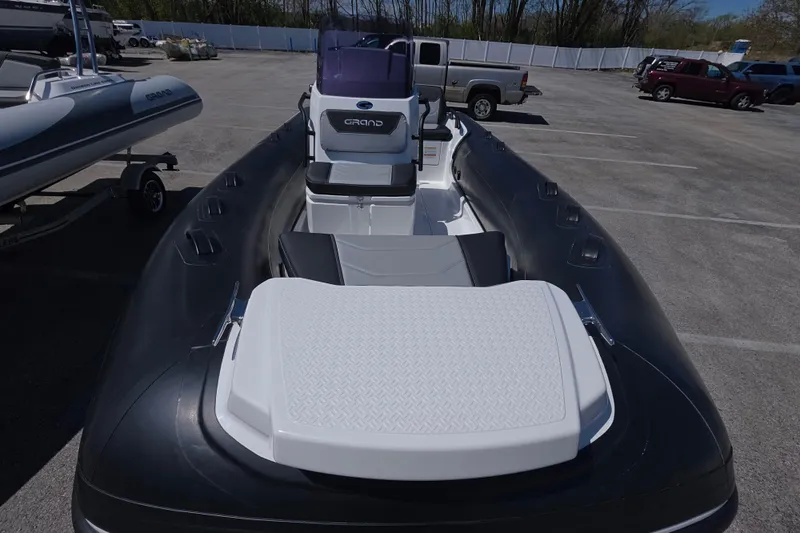 Slide: The Image of 2026 Grand Inflatables G420 boat in parking lot, showcasing sleek design and spacious seating. - 8