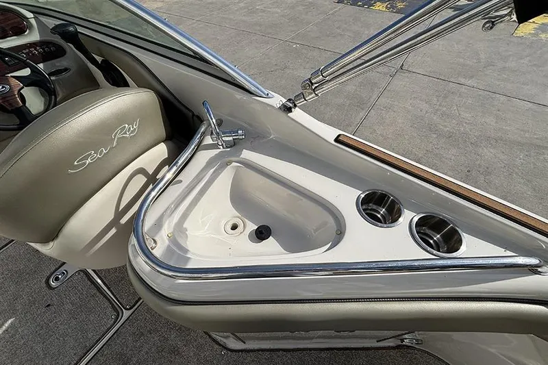 Slide: The Image of 2005 Sea Ray 240 Sundeck interior with sink and cup holders. - 12