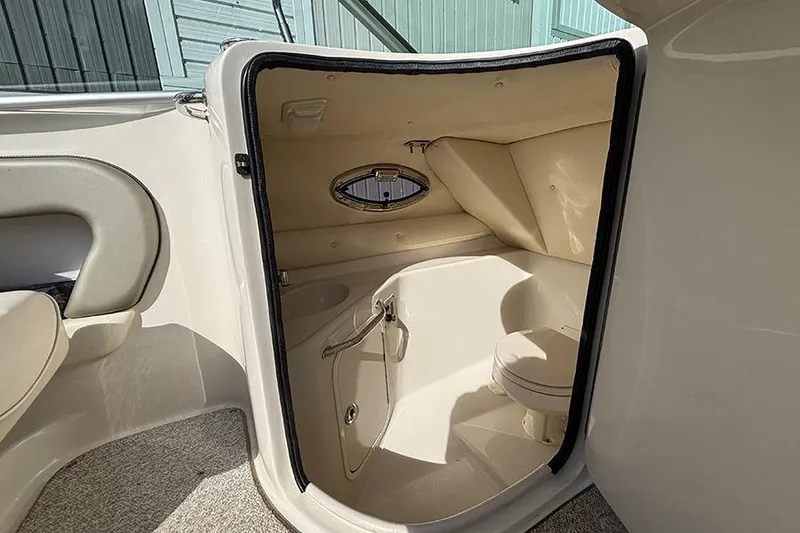 Slide: The Image of Interior view of 2005 Sea Ray 240 Sundeck boat's compact bathroom area. - 14