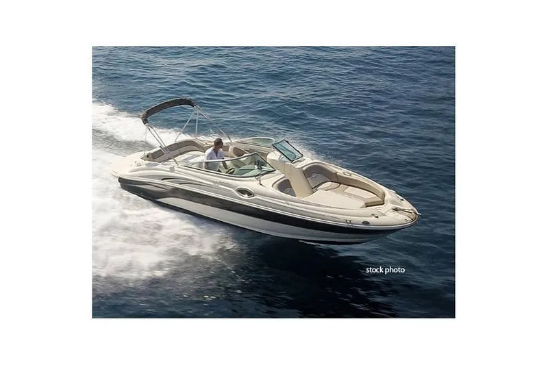 The Image of 2005 Sea Ray 240 Sundeck boat cruising on open water, side view. - 2