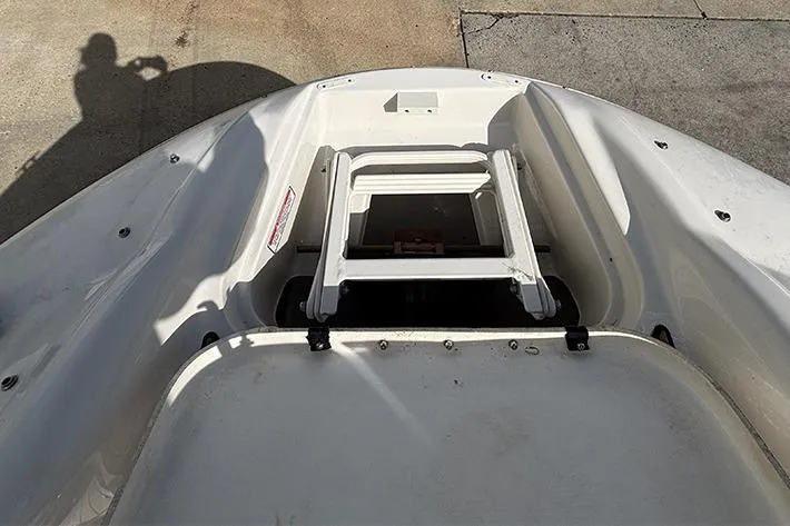 Slide: The Image of 2005 Sea Ray 240 Sundeck boat with a folded ladder on deck. - 26