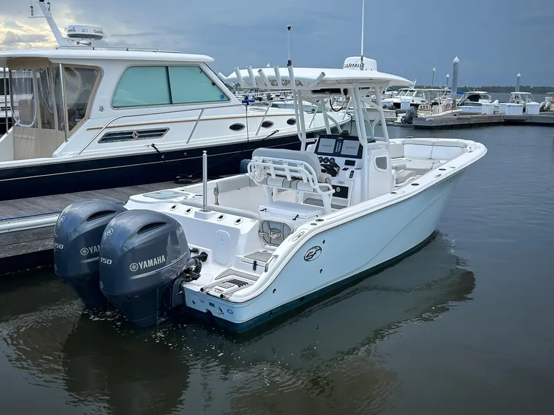 Slide: The Image of 2022 Sea Fox 268 Commander boat docked with twin Yamaha engines. - 14