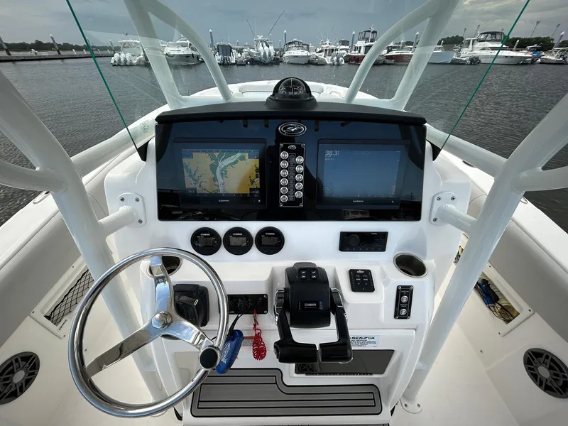 Slide: The Image of 2022 Sea Fox 268 Commander boat dashboard with navigation screens and steering wheel. - 3