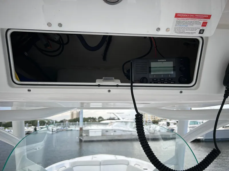 Slide: The Image of 2022 Sea Fox 268 Commander boat dashboard with radio equipment and marina view. - 6
