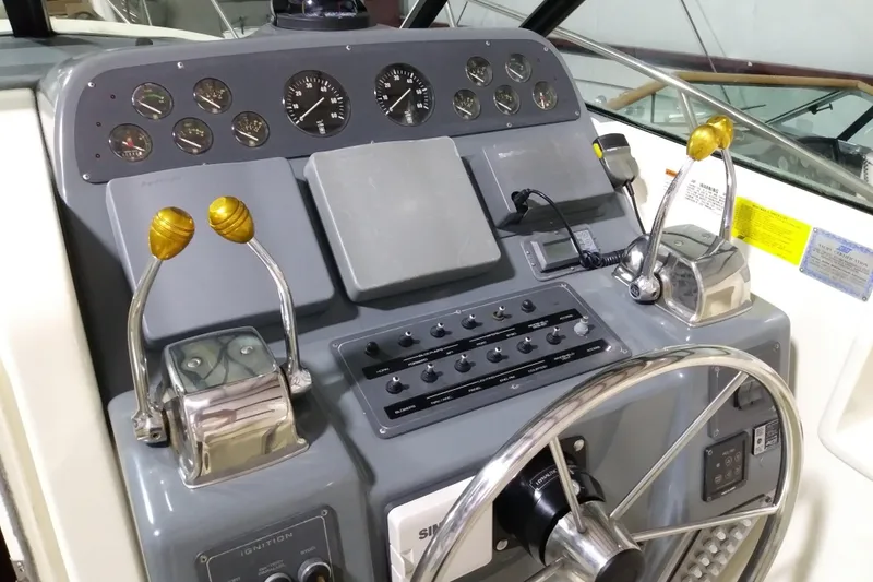 Slide: The Image of Control panel of a 1993 Tiara 3100 Open boat with steering wheel and throttle levers. - 10