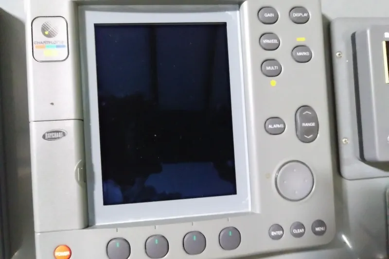 Slide: The Image of Control panel of a 1993 Tiara 3100 Open boat with various buttons and display. - 16