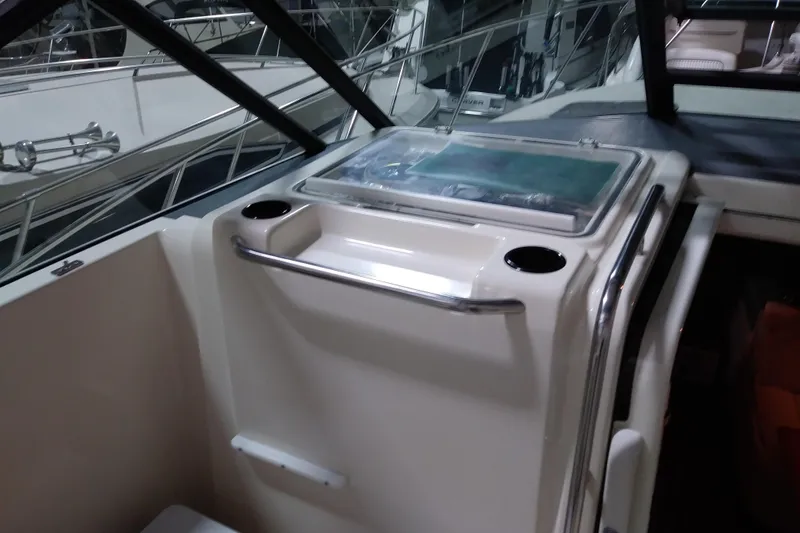 Slide: The Image of 1993 Tiara 3100 Open boat interior with cup holders and storage compartment. - 19