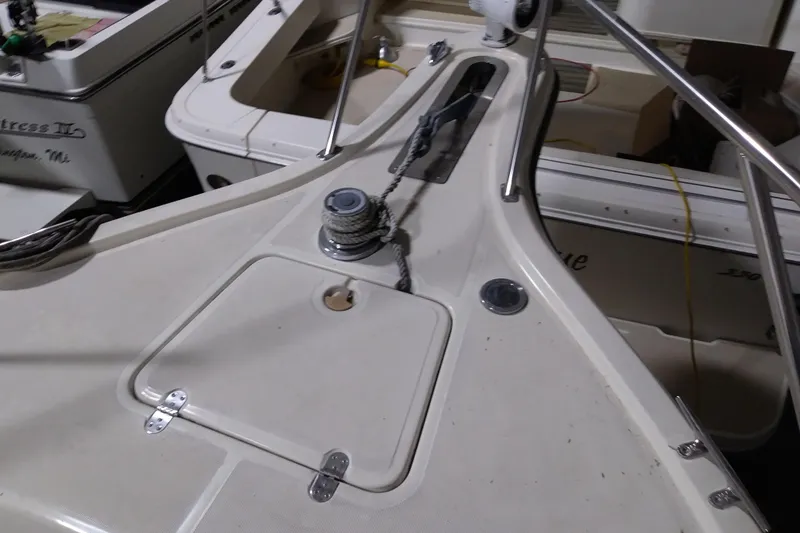 Slide: The Image of 1993 Tiara 3100 Open boat deck with winch and railing in a marina. - 20