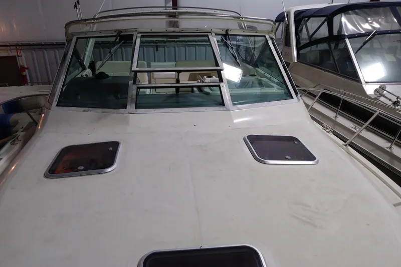 Slide: The Image of 1993 Tiara 3100 Open boat with windshield and hatches, docked indoors. - 21