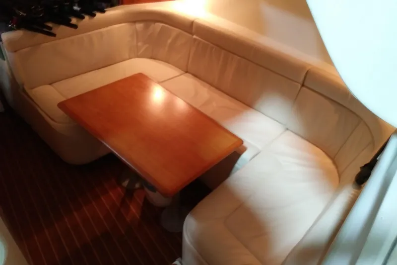 Slide: The Image of Luxurious interior of 1993 Tiara 3100 Open yacht with plush seating and wooden table. - 22