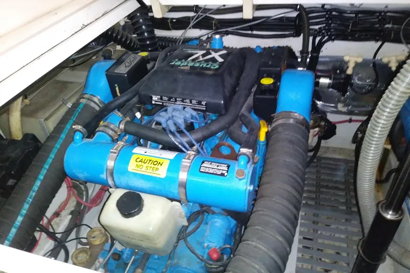 Slide: The Image of Engine compartment of a 1993 Tiara 3100 Open boat, featuring a blue engine. - 32