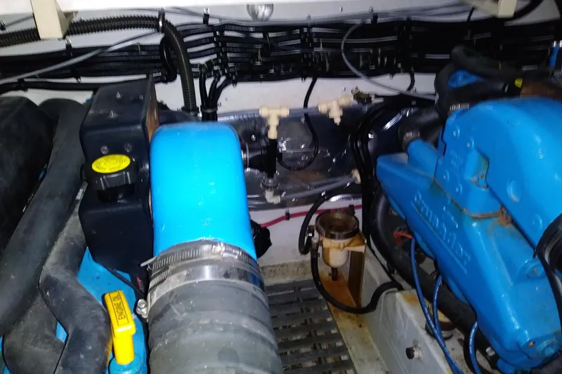 Slide: The Image of Engine compartment of a 1993 Tiara 3100 Open boat, featuring blue components. - 33