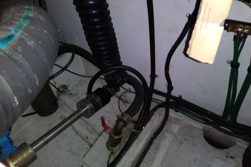 Slide: The Image of Engine compartment of a 1993 Tiara 3100 Open boat, showing hoses and fittings. - 34