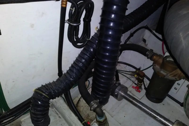 Slide: The Image of Engine compartment of a 1993 Tiara 3100 Open boat, showing hoses and fittings. - 35